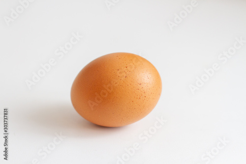 beautiful brown oval shaped chicken egg on a white background