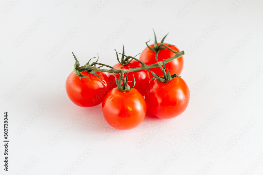 cherry tomatoes on a branch isolated on white background