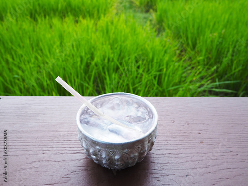 Thai vintage water bowl over rice field background.
