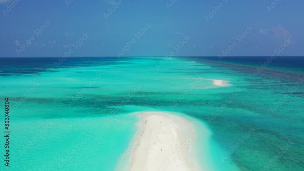 Large turquoise lagoon with calm water and beautiful patterns of white sandy dunes exposed under clear blue sky in Maldives Large turquoise lagoon with calm water and beautiful patterns of white sandy dunes exposed under clear blue sky in Maldives