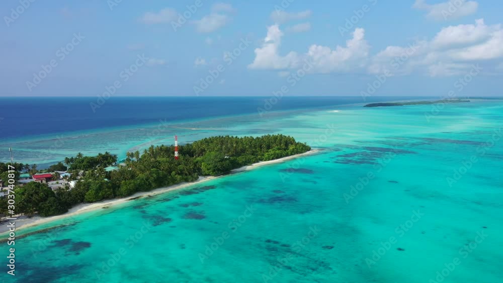 Remote tropical island of Maldivian archipelago in the middle of Indian ocean and tall antenna for communication with world afar Remote tropical island of Maldivian archipelago in the middle of Indian ocean and tall antenna for communication with world afar