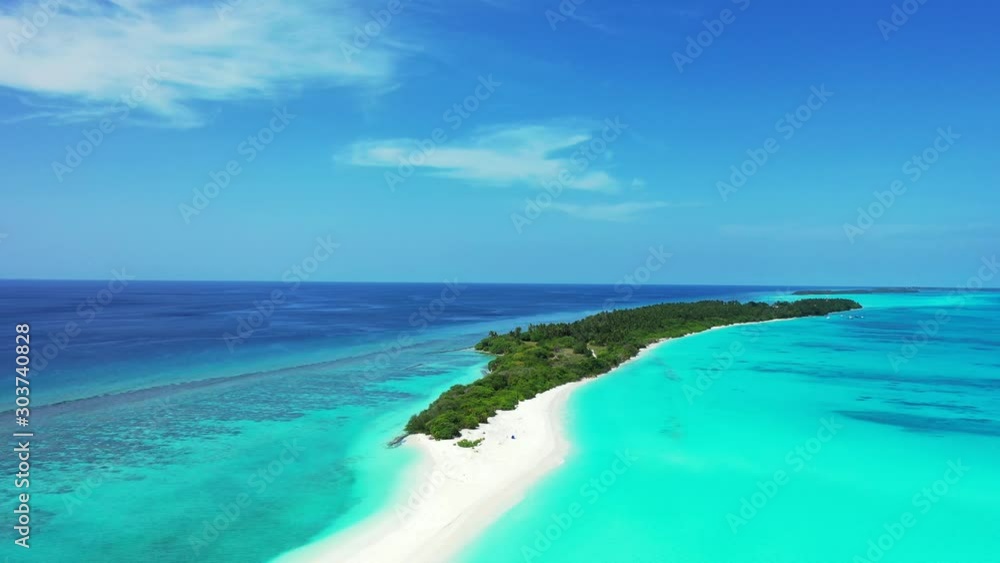 Idyllic tropical island with lush vegetation on the edge of atoll surrounded by coral reef and turquoise lagoon in Seychelles Idyllic tropical island with lush vegetation on the edge of atoll surrounded by coral reef and turquoise lagoon in Seychelles