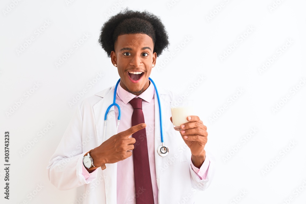 Young african american doctor man drinking glass of milk over isolated white background very happy pointing with hand and finger Young african american doctor man drinking glass of milk over isolated white background very happy pointing with hand and finger