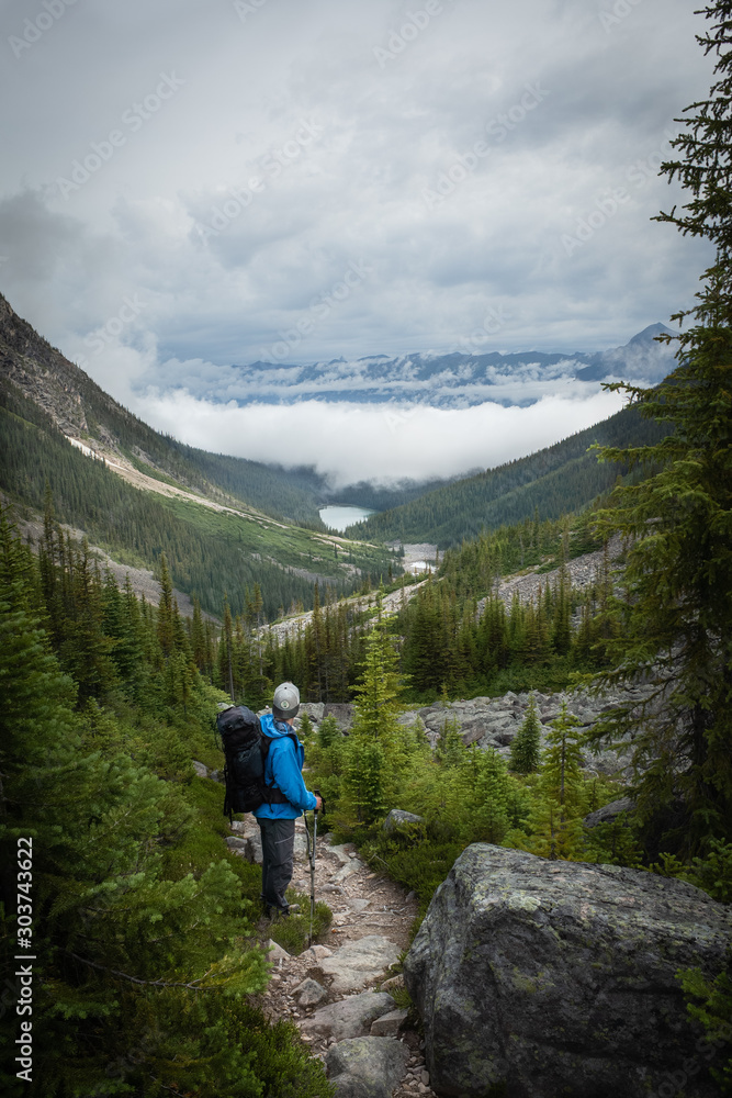 Young adventure healthy man is hiking Geraldine Lakes trail in Jasper National park,  Alberta, Canada. Solo traveling backpacker