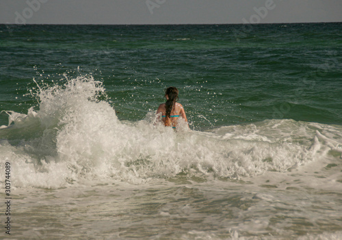 Girl Playing In Rough Surf