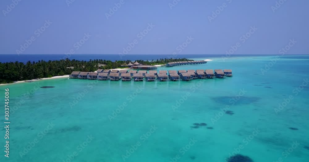 Luxurious bungalows built over shallow transparent waters of calm turquoise lagoon near tropical island in Maldives Luxurious bungalows built over shallow transparent waters of calm turquoise lagoon near tropical island in Maldives