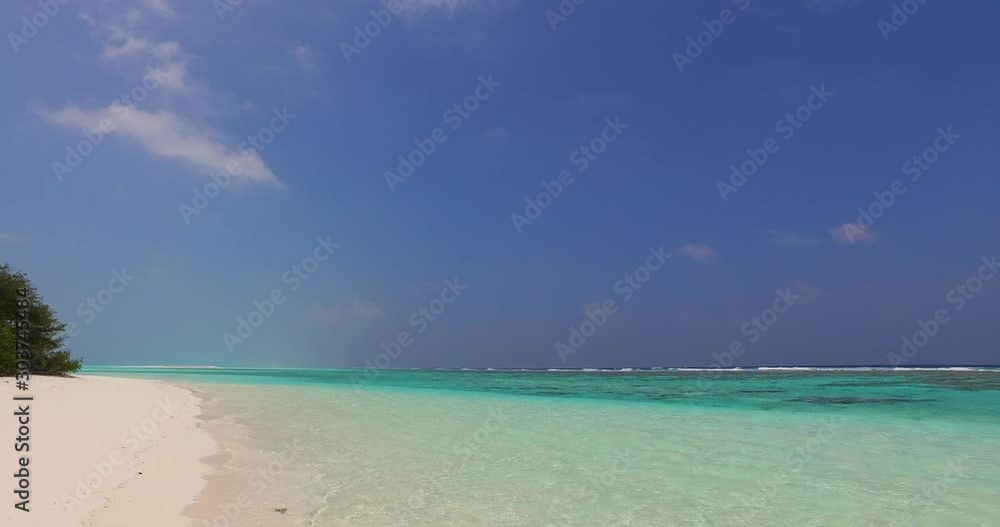 Dusty purple sky shades over calm turquoise lagoon with clear vibrant water washing white sand of exotic beach in Cook islands Dusty purple sky shades over calm turquoise lagoon with clear vibrant water washing white sand of exotic beach in Cook islands