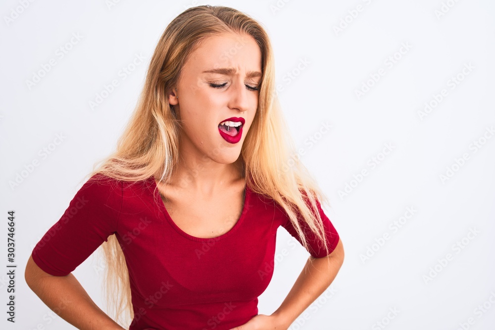 Young beautiful woman wearing red t-shirt standing over isolated white background with hand on stomach because indigestion, painful illness feeling unwell. Ache concept. Young beautiful woman wearing red t-shirt standing over isolated white background with hand on stomach because indigestion, painful illness feeling unwell. Ache concept.