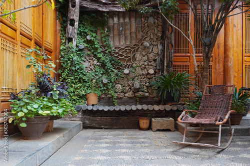 Beautiful Naxi style courtyard at Lijaing with a rattan made rocking chair, China. 