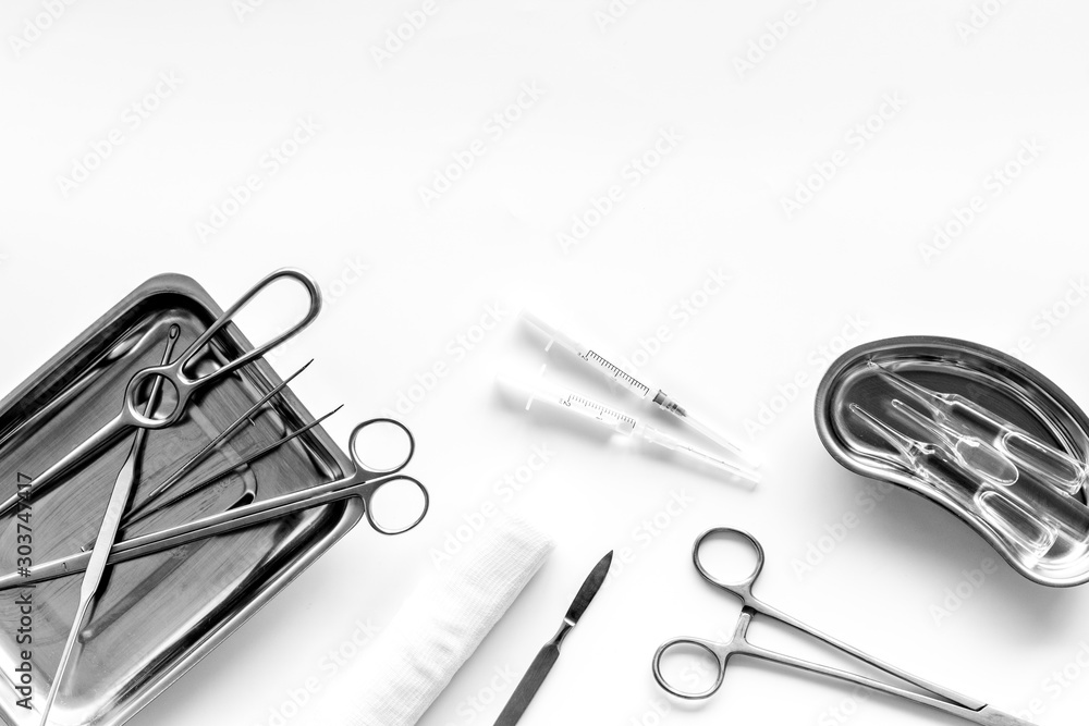 Plastic surgery instruments and tools with bandage on white background top view frame copy space - obrazy, fototapety, plakaty 