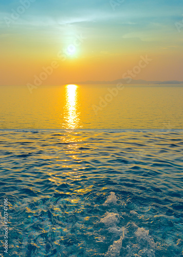 Swimming Pool with sunset on the sea