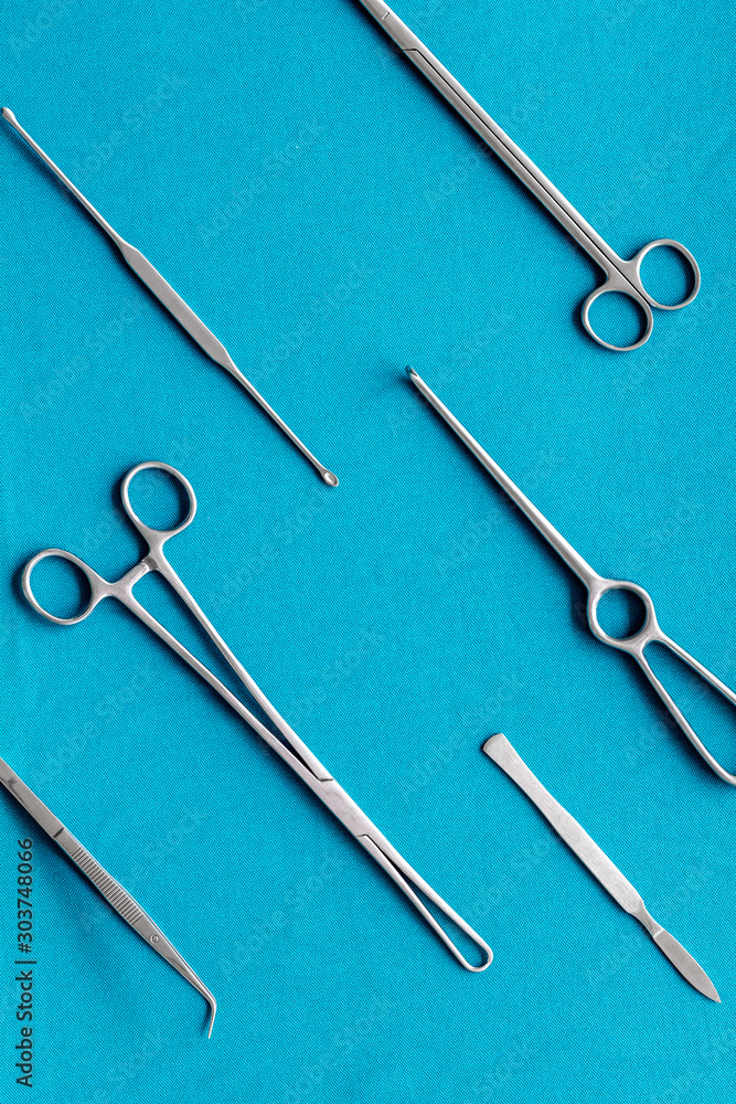 Plastic surgery. Instruments for beauty operations on blue background top view pattern Plastic surgery. Instruments for beauty operations on blue background top view pattern
