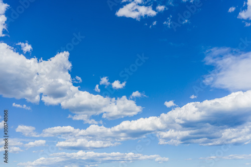 Blue sky on a sunny day with fluffy clouds