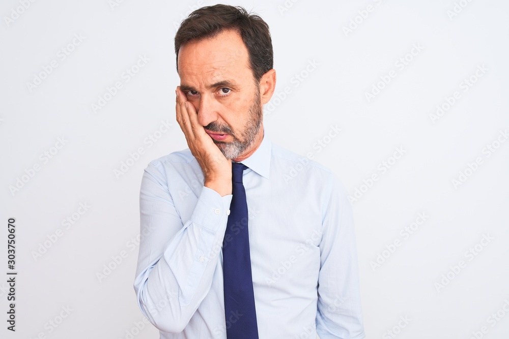 Middle age businessman wearing elegant tie standing over isolated white background thinking looking tired and bored with depression problems with crossed arms. Middle age businessman wearing elegant tie standing over isolated white background thinking looking tired and bored with depression problems with crossed arms.