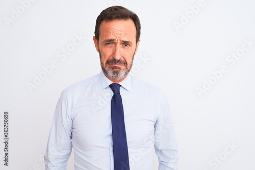 Middle age businessman wearing elegant tie standing over isolated white background depressed and worry for distress, crying angry and afraid. Sad expression.