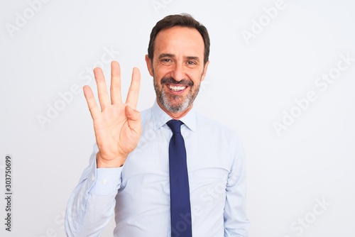 Middle age businessman wearing elegant tie standing over isolated white background showing and pointing up with fingers number four while smiling confident and happy.