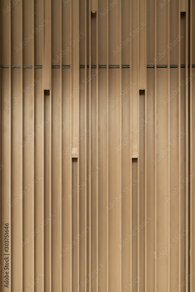 Naklejka premium Detail of Random wooden strip wall in vertical direction at pre-function space / interior / natural light