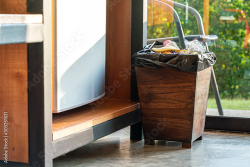 Garbage bin filled with garbage in the home kitchen