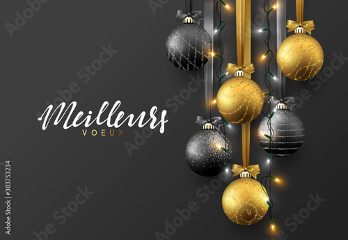Meillieurs voeux Joyeux Noel. Christmas greeting card, design of xmas ball black and gold with realistic garlands on dark background.