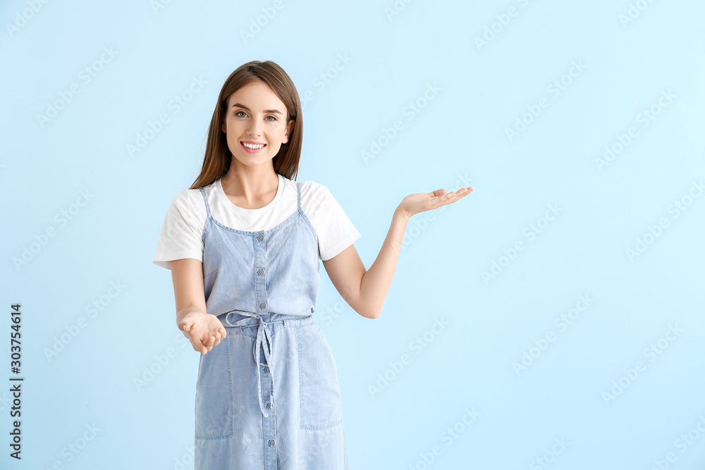 Beautiful young woman inviting viewer on color background Beautiful young woman inviting viewer on color background