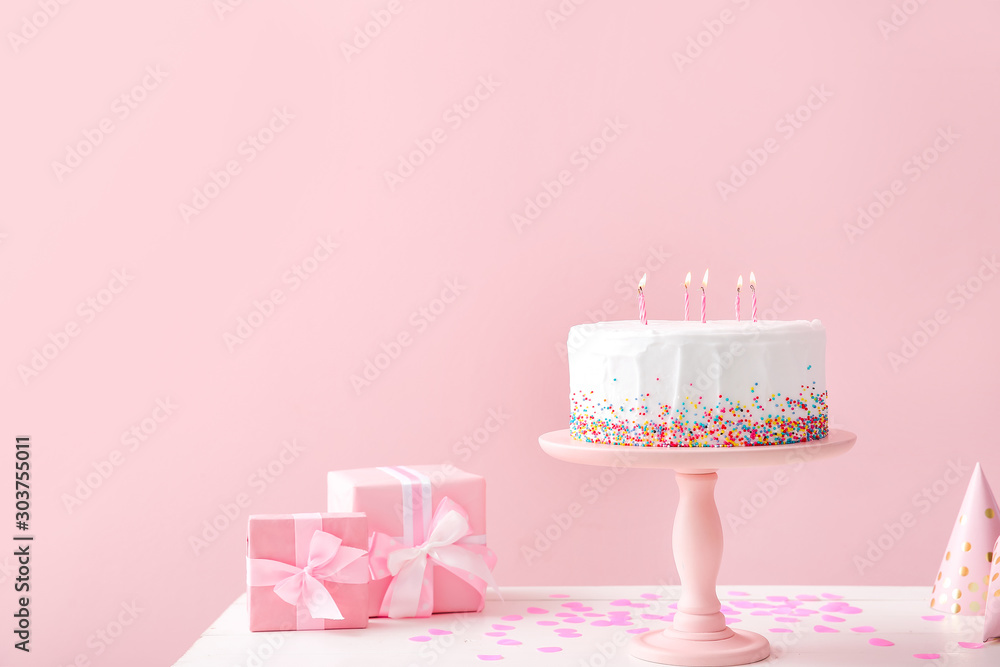 Εκτύπωση καμβά Tasty Birthday cake with gifts on table against color background