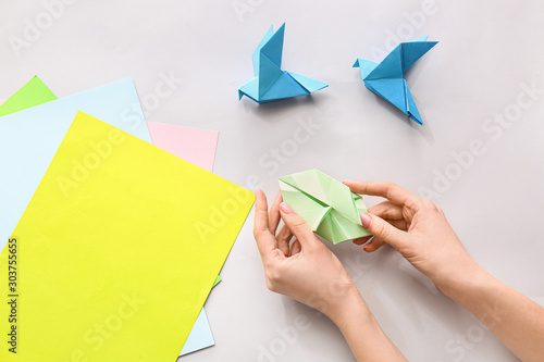 Woman making origami figure...