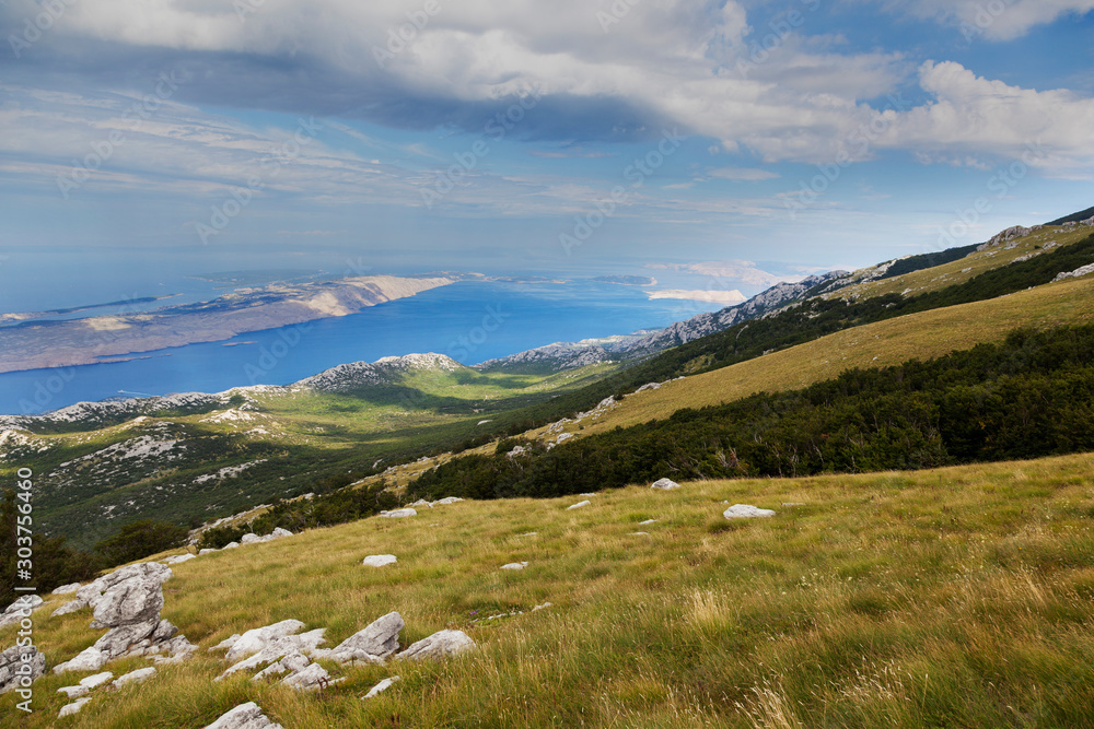 Fototapeta premium Aerial scene of Velebit Mountain and the Adriatic Sea in the background, Croatia