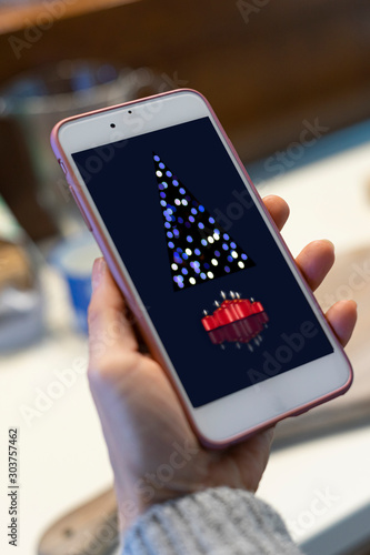 Woman receiving congratulations on her cellphone.Christmas holiday greeting design mockup