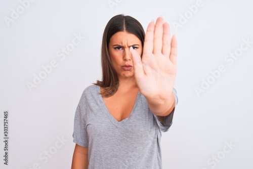 Wallpaper Mural Portrait of beautiful young woman standing over isolated white background doing stop sing with palm of the hand. Warning expression with negative and serious gesture on the face. Torontodigital.ca