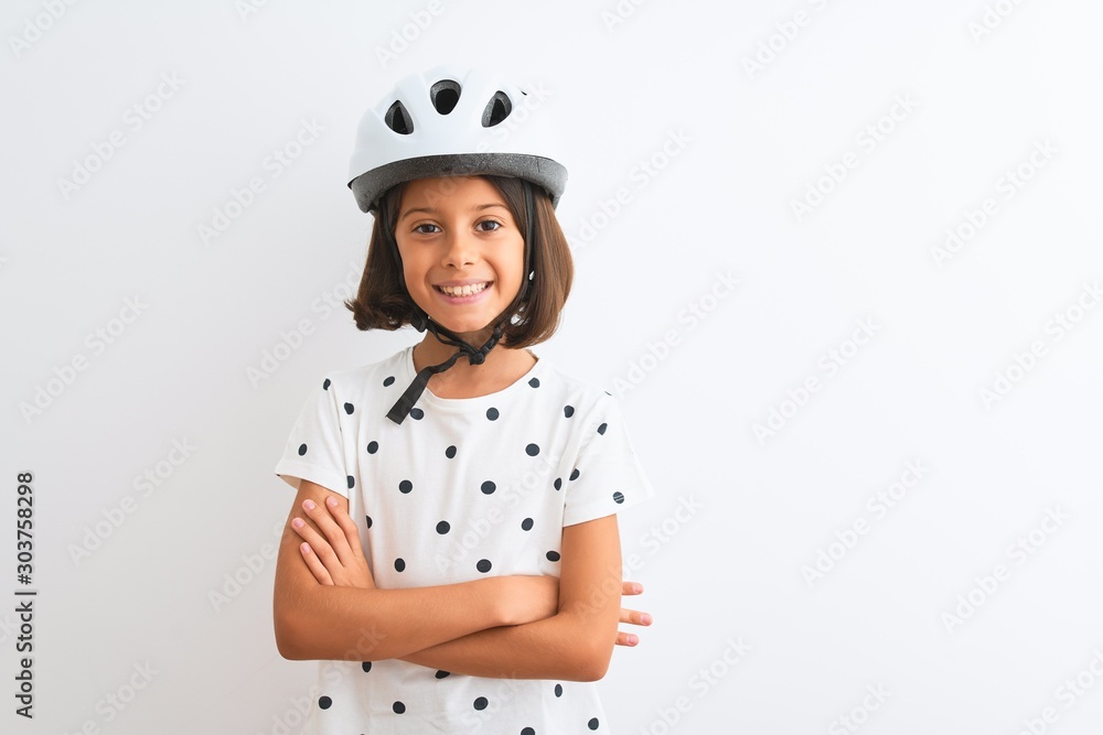 Beautiful child girl wearing security bike helmet standing over isolated white background happy face smiling with crossed arms looking at the camera. Positive person. Beautiful child girl wearing security bike helmet standing over isolated white background happy face smiling with crossed arms looking at the camera. Positive person.