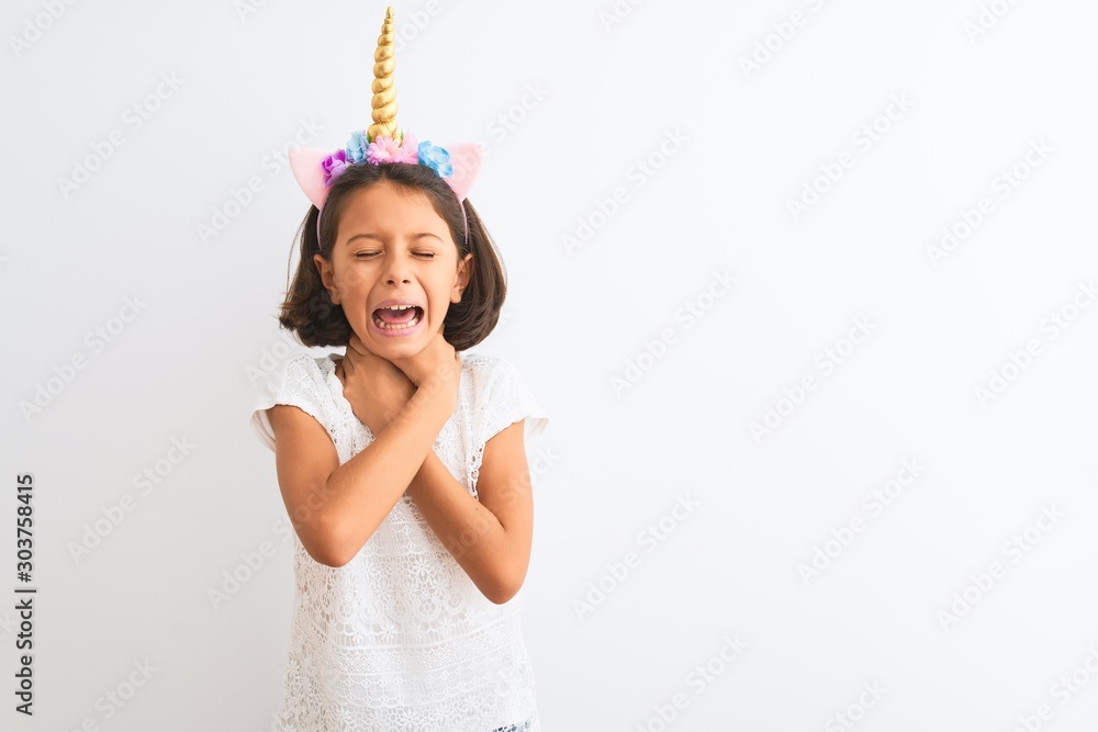 Beautiful child girl wearing unicorn diadem standing over isolated ...