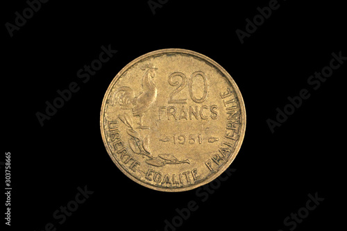 An old twenty French franc coin, shot close up in macro, on a black background