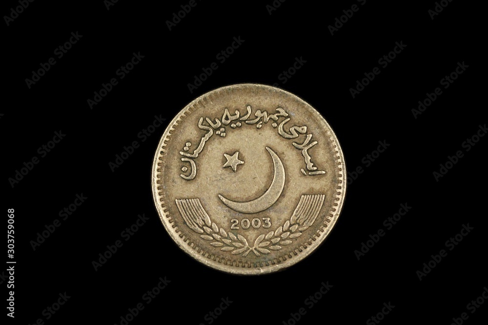 A macro image of an two rupee coin from Pakistan, shot close up, against a black background A macro image of an two rupee coin from Pakistan, shot close up, against a black background