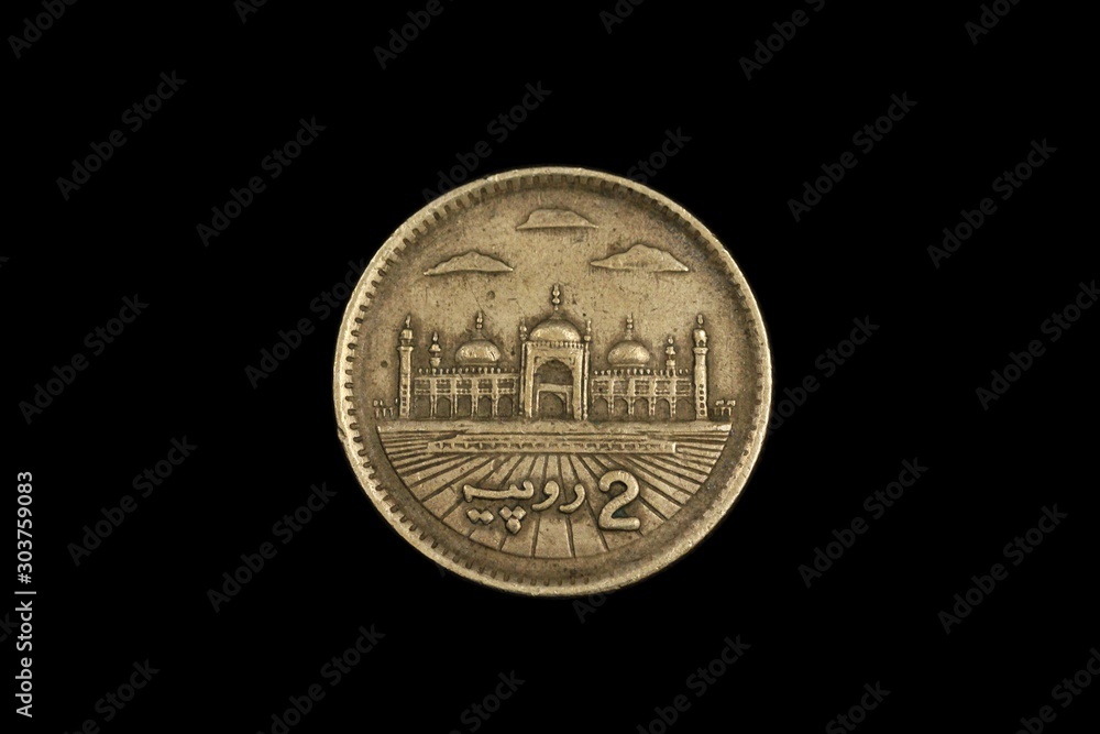 A macro image of an two rupee coin from Pakistan, shot close up, against a black background A macro image of an two rupee coin from Pakistan, shot close up, against a black background