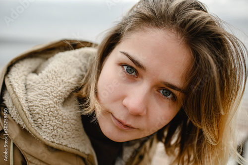 close-up portrait of a girl with blue-gray eyes looking directly at the camera