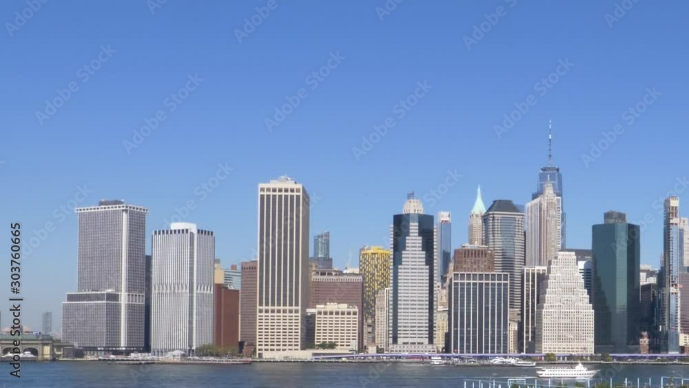 Lower Manhattan Skyline, East River and Skies Pan to Right underneath clear blue skies Lower Manhattan Skyline, East River and Skies Pan to Right underneath clear blue skies