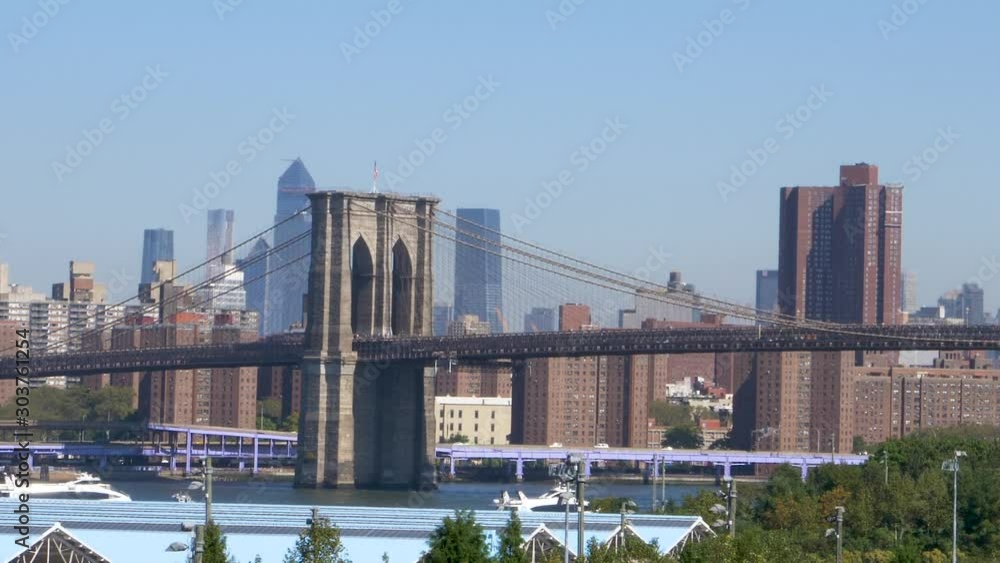 Zooming out from Brooklyn Bridge reveals Manhattan Skyline under clear skies Zooming out from Brooklyn Bridge reveals Manhattan Skyline under clear skies