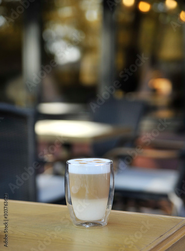 Cup of cappuccino on wooden background.