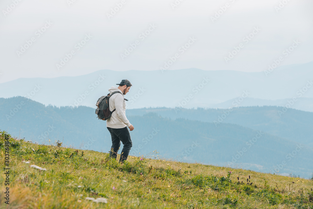 man with backpack hiking in mountains man with backpack hiking in mountains
