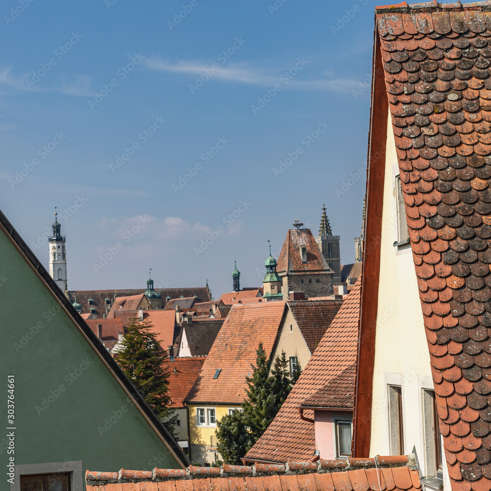 traditional red tiled roofs of the German city of Dinkelsbühl with cathedral spiers in the background