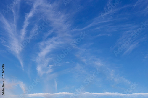beautiful blue sky with white cirrus clouds to the horizon