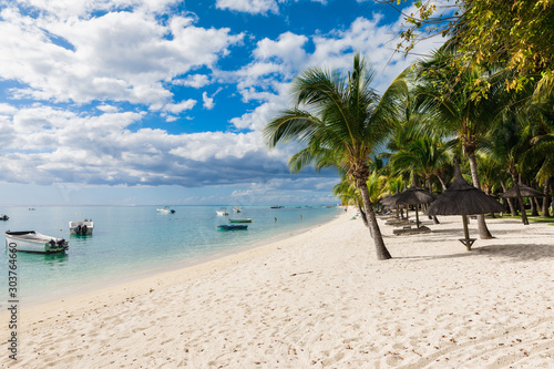 Fototapeta Naklejka Na Ścianę i Meble -  Luxury beach in Mauritius with transparent ocean, white sand beach, palms and sky