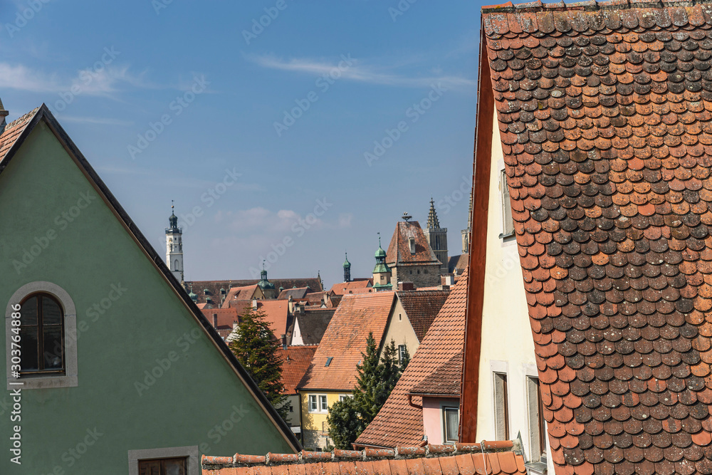 traditional red tiled roofs of the German city of Dinkelsbühl with cathedral spiers in the background