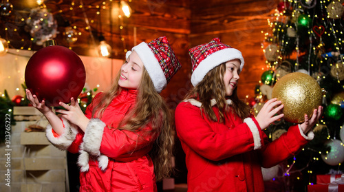 Best holiday. Elf children. Xmas children. Christmas time. Elf children. Little girl sisters in red hats. Christmas elf. Happy new year. Children like elf character. Santa claus little girls sisters photo