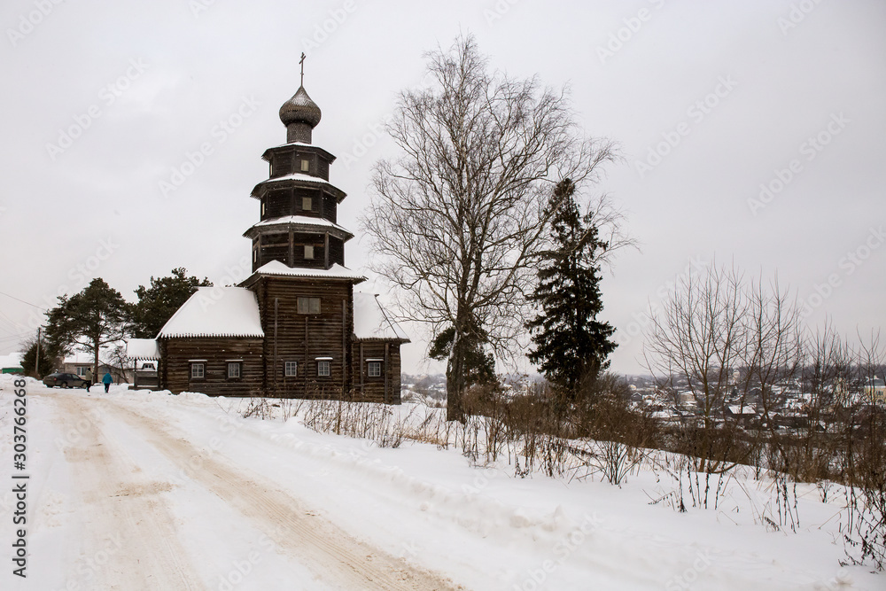 The old wooden Church is located on a hill. Winter landscape. Torzhok, Russia.