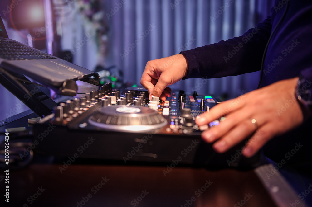 close up photo of a DJ mixing in the dark close up photo of a DJ mixing in the dark