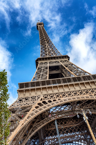 Beautiful view of the Eiffel Tower against a bright blue sky on a sunny day. Vertical.