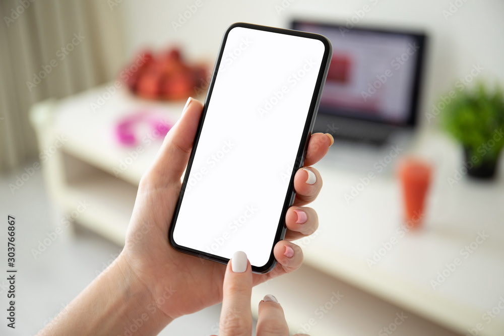 female hands holding phone with isolated screen in a room female hands holding phone with isolated screen in a room