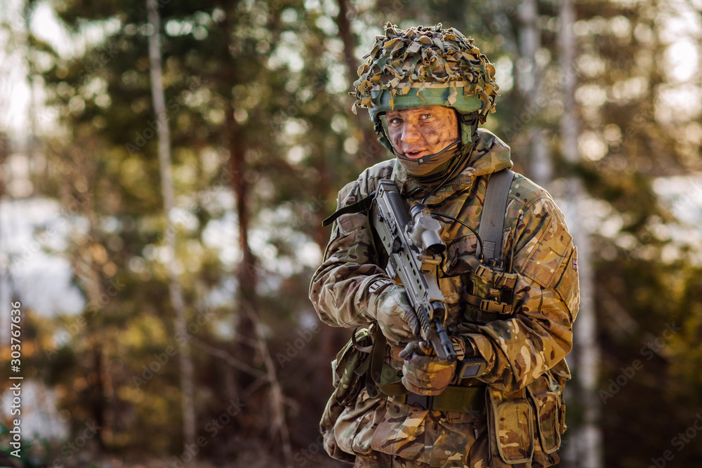 British special forces soldier with weapon take part in military maneuver. war, army, technology and people concept.