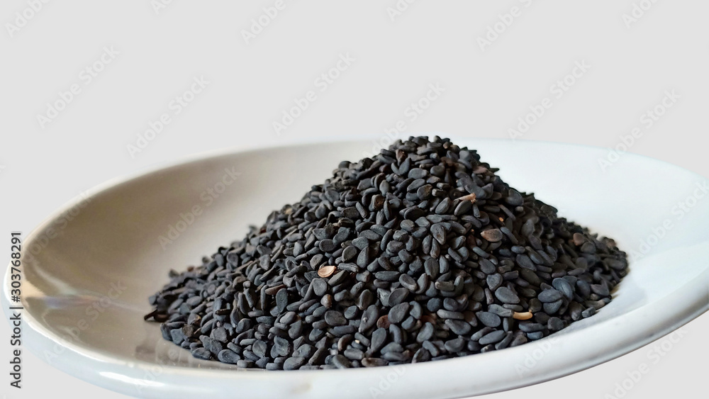 black sesame seeds in a bowl isolated on white black sesame seeds in a bowl isolated on white
